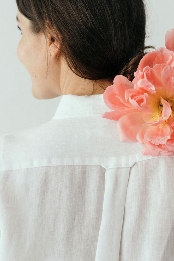 Happy woman with a bouquet of coral sunset peony