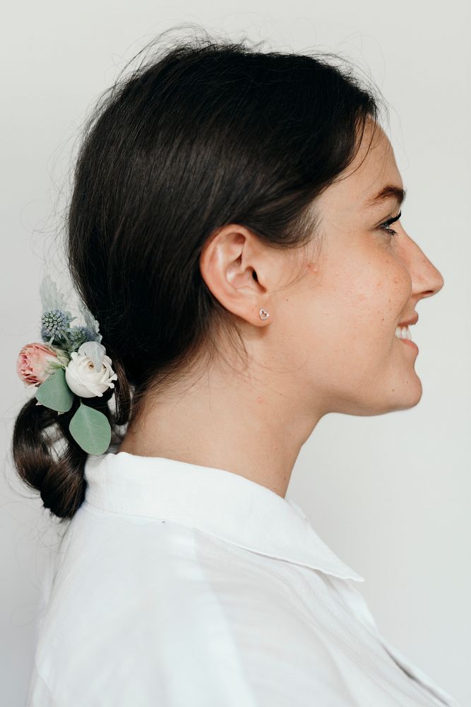 Profile portrait  of a woman wearing flowers in her hair