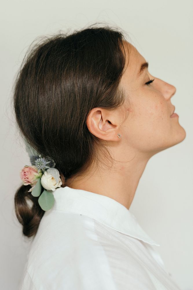 Profile portrait  of a woman wearing flowers in her hair