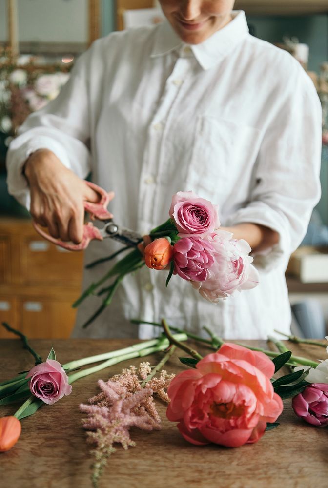 Woman preparing and arranging flowers