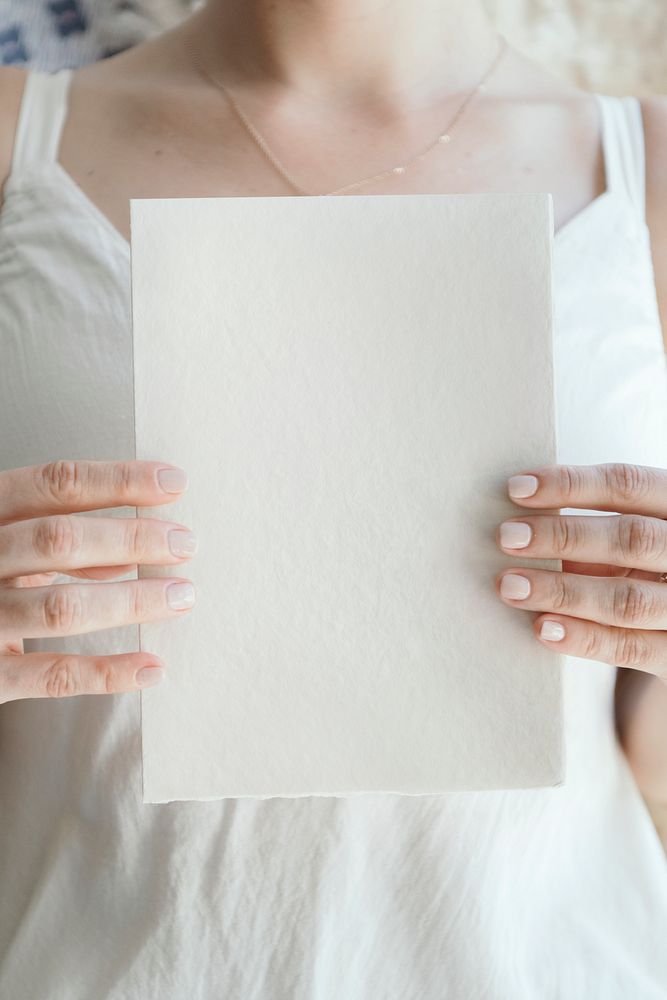 Bride holding a blank white card