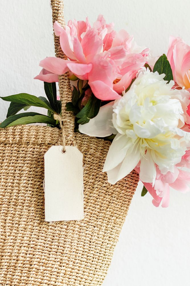 Beautiful peonies in a wicker bag