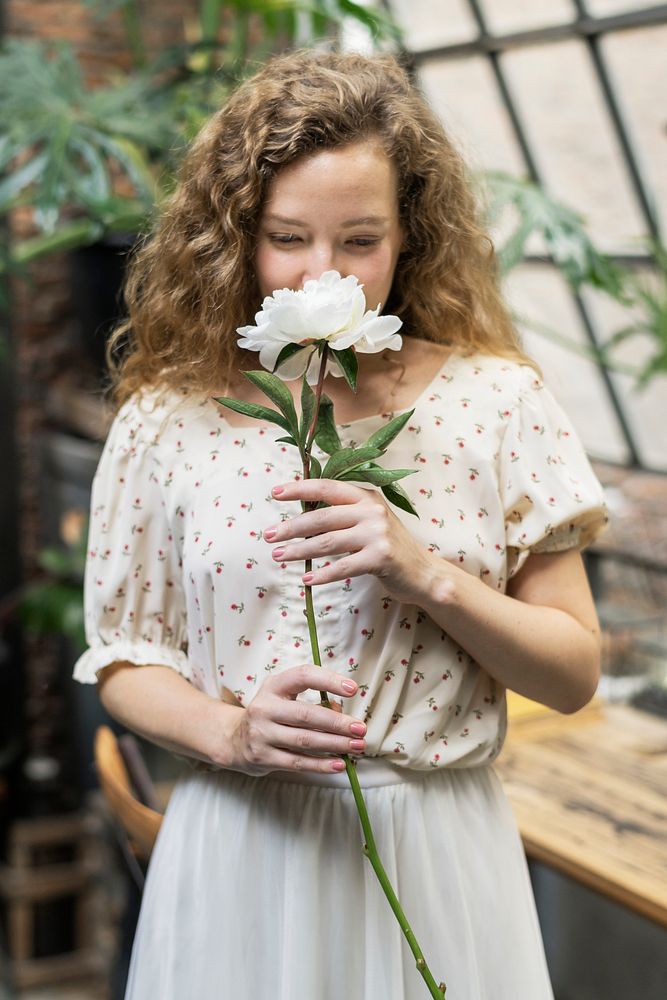 Woman with a white paeonia snowboard flower