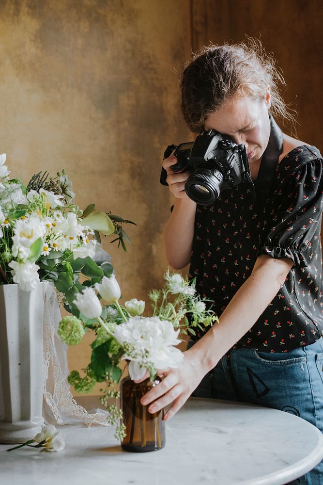 Photographer taking a photo of a bouquet
