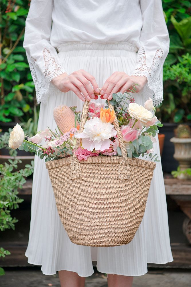 Woman carrying flowers in a wicker bag