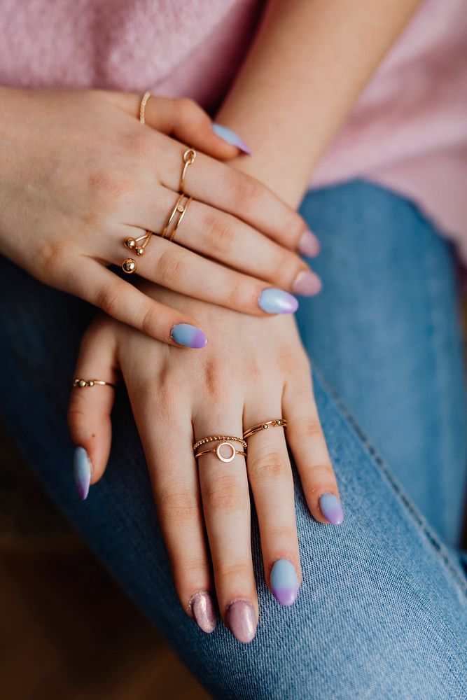 Closeup of painted nails and rings on her fingers