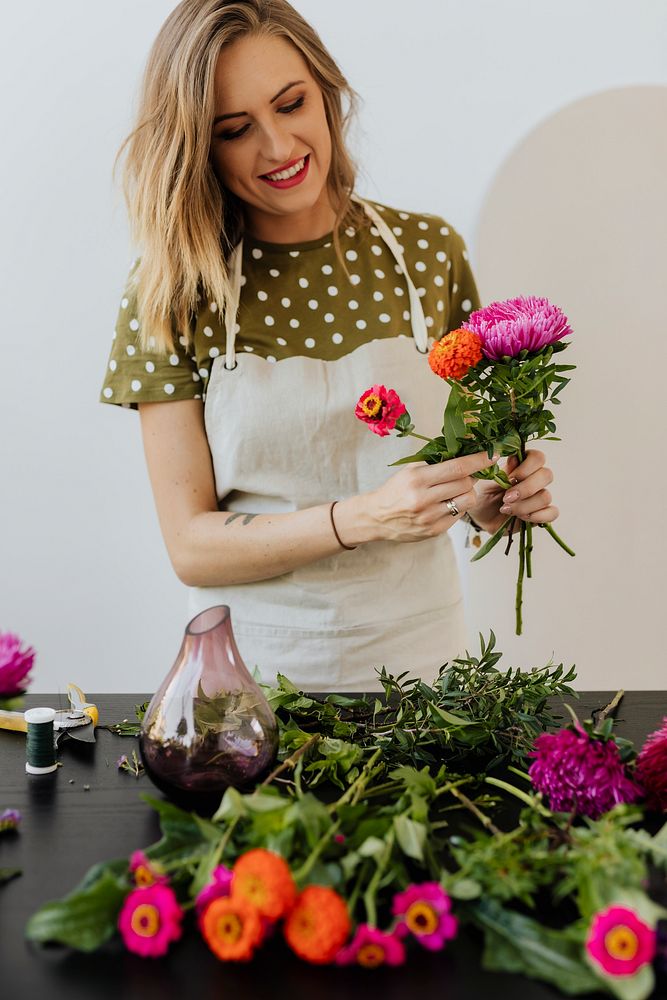 Blond woman making a bouquet of flowers