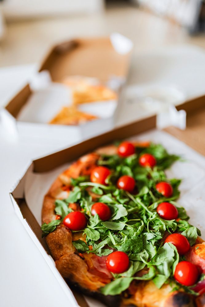 Slices of rocket and tomato pizza