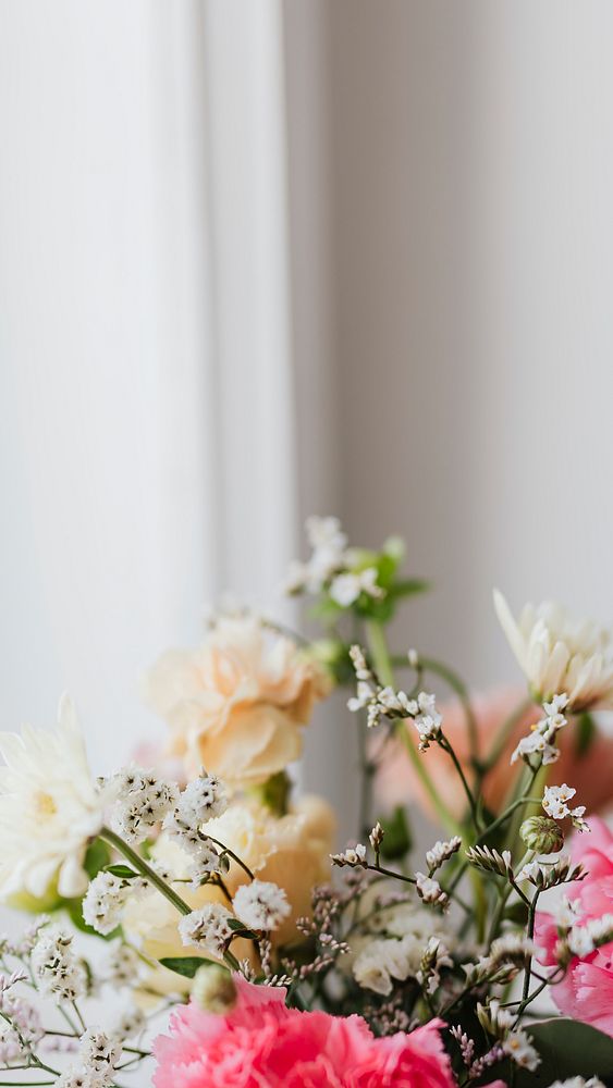 Closeup of carnations in a vase by the window