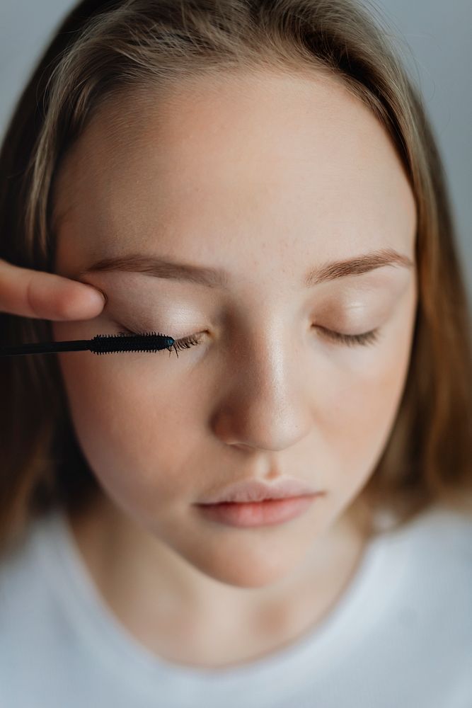 Beauty blogger applying mascara to her model