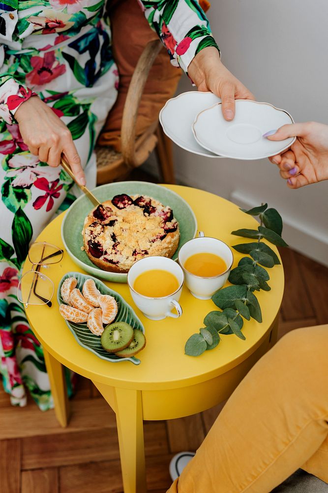 Woman cutting a slice of plum crumble pie