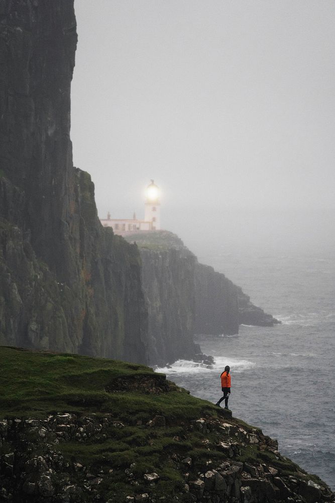 Female photographer at Neist Point Lighthouse, Isle of Skye, Scotland