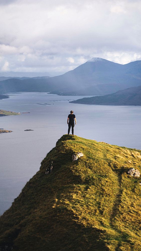 Man standing at Isle of Skye, Scotland mobile phone wallpaper