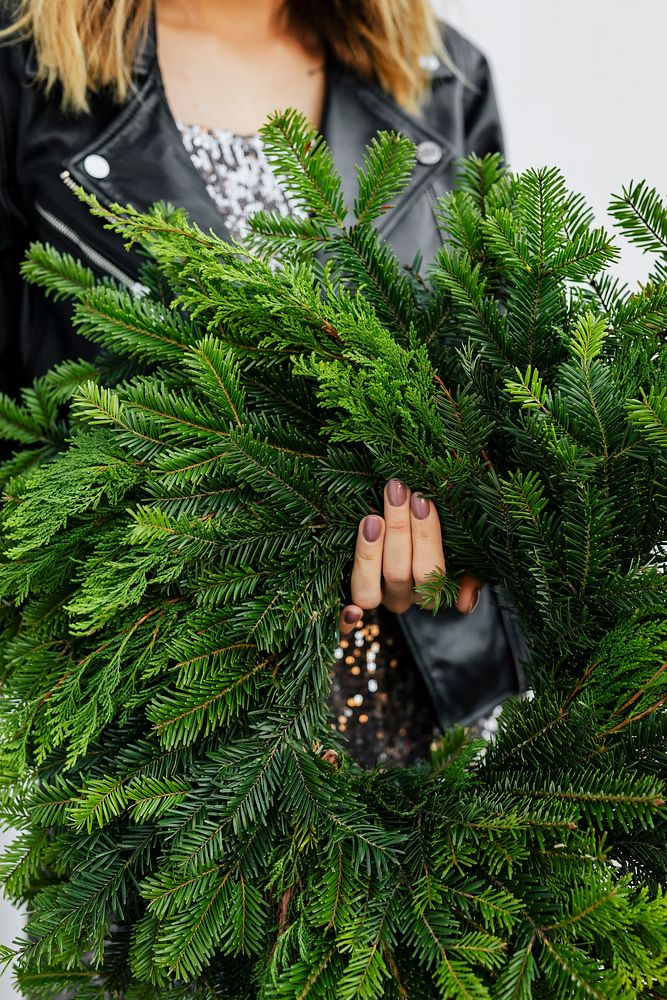 Woman holding a green Christmas wreath 