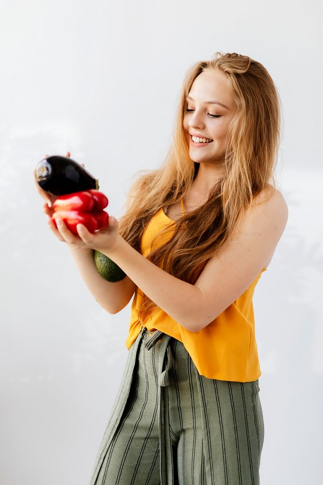 Blond woman holding fruit and vegetables