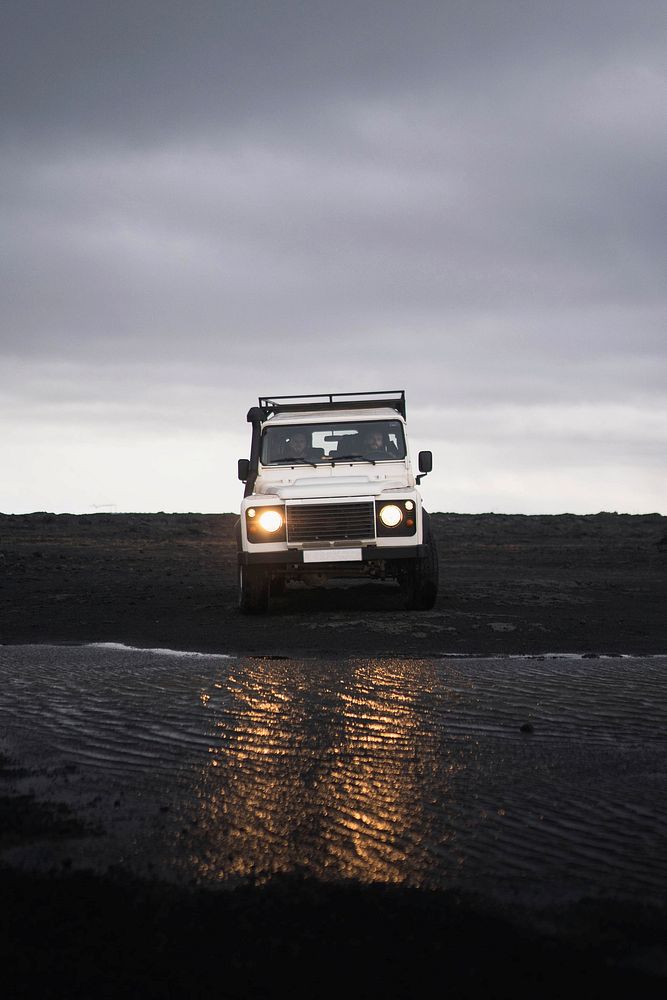 Land Rover crossing the puddle on the dirt road