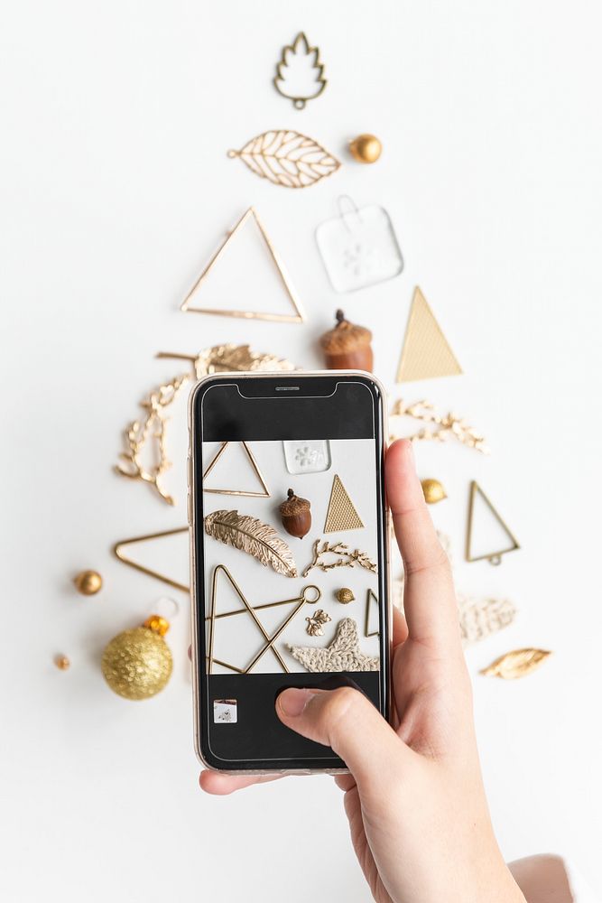 Woman capturing a gold ornament Christmas tree