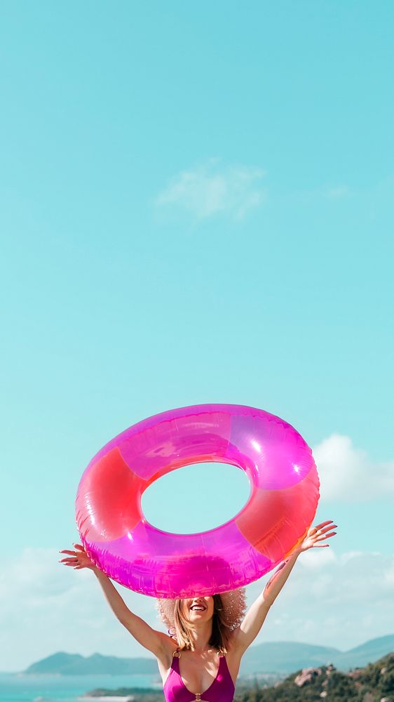 Girl in a bikini holding a pink swim tube mobile phone wallpaper