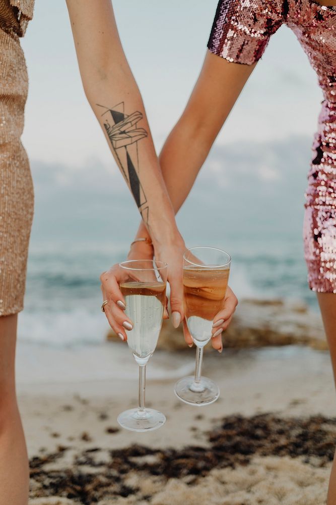 Women with glasses of champagne at the beach