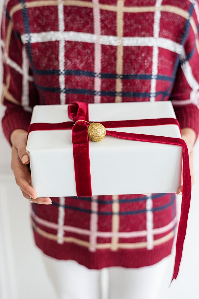 Woman holding a white present