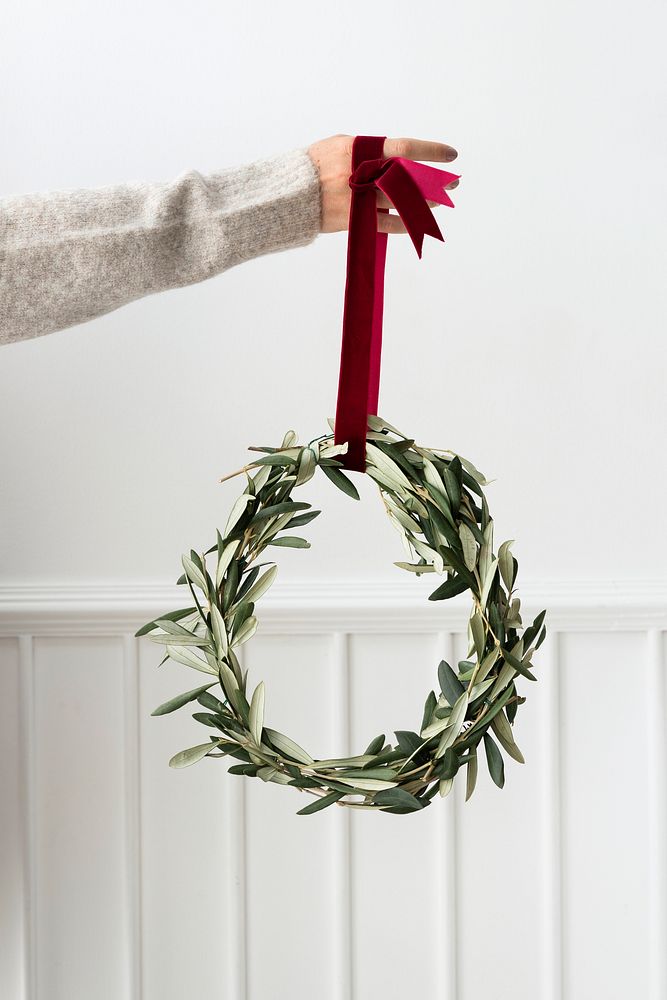 Woman holding a fresh Christmas wreath