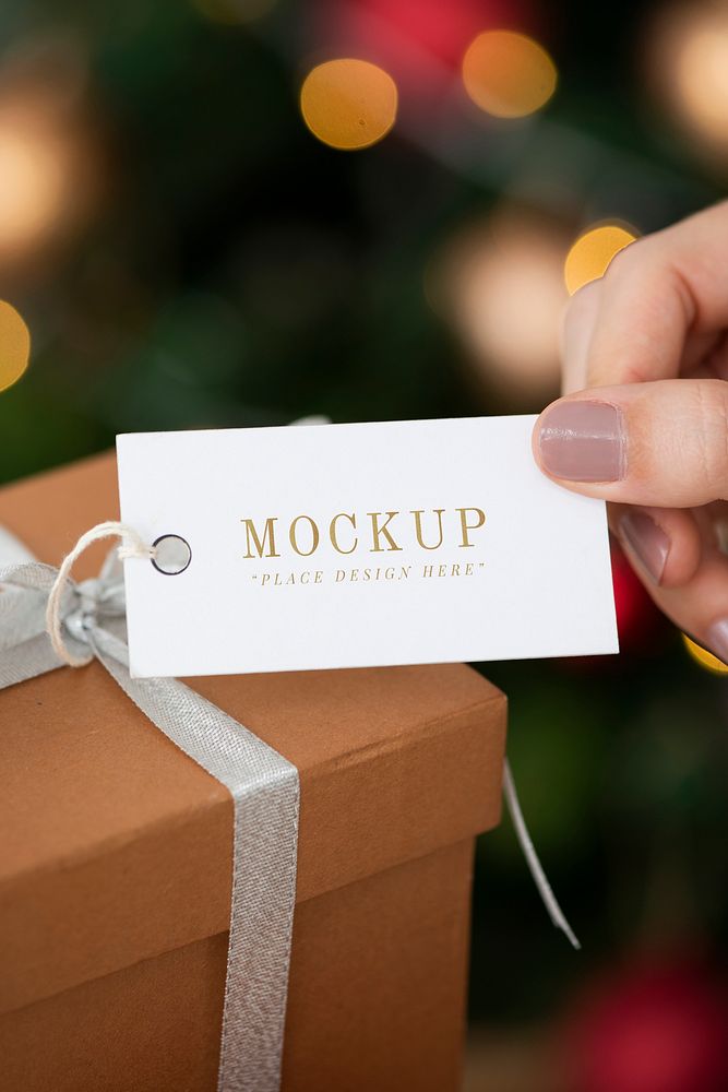 Woman holding a brown present with a white card mockup