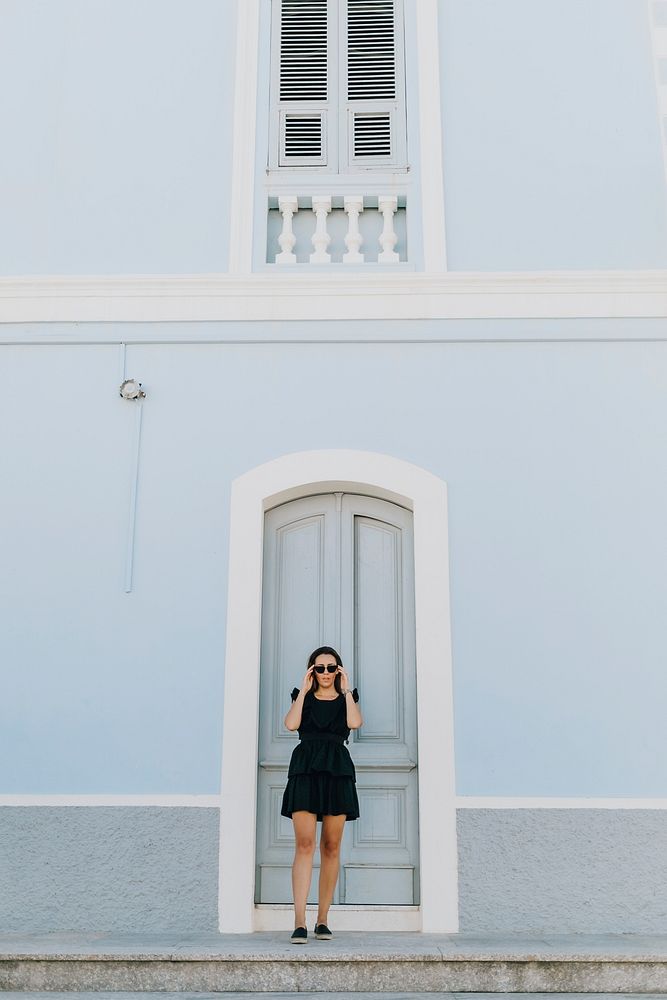 Woman in a black dress at a beach town
