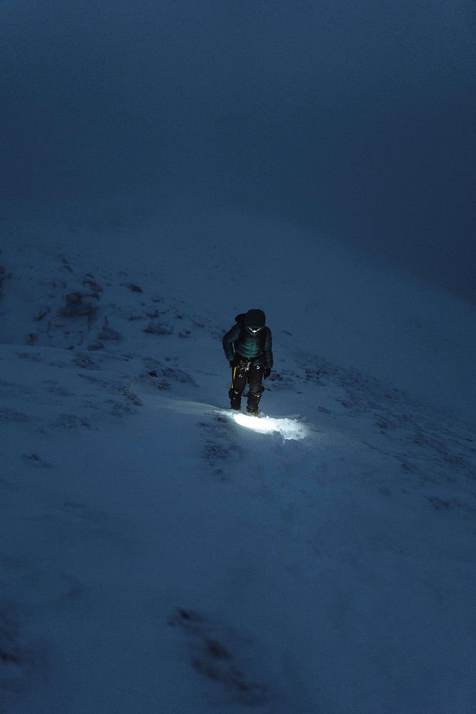Mountaineer trekking in a cold night at Liathach Ridge, Scotland