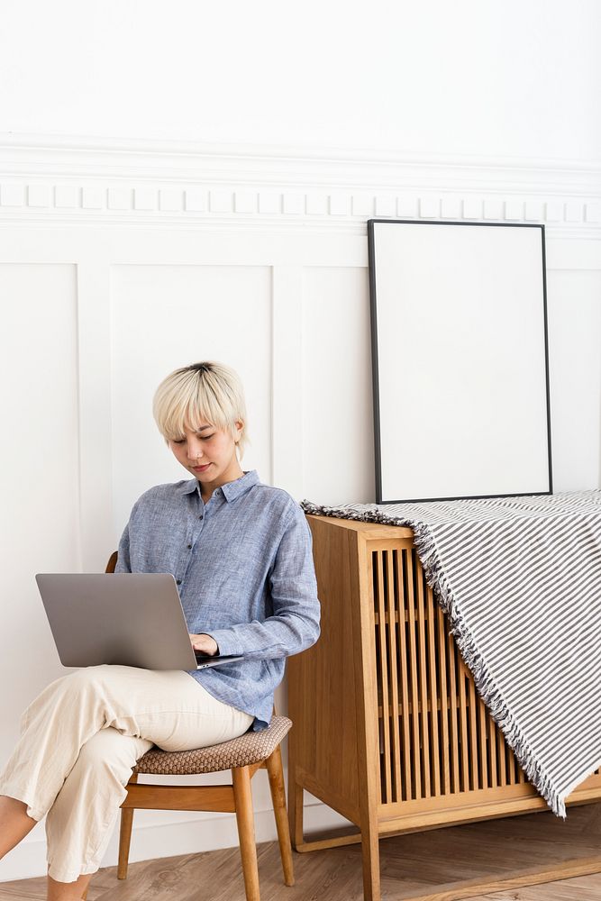 Asian wman sitting in her modern living room