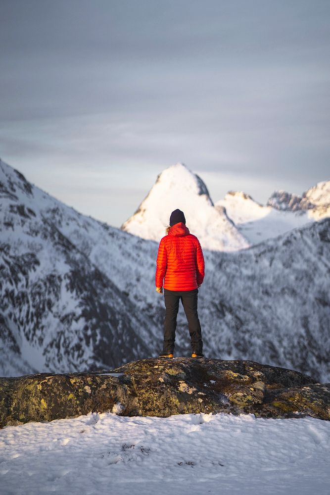 Hiker walking up Segla mountain in Norway
