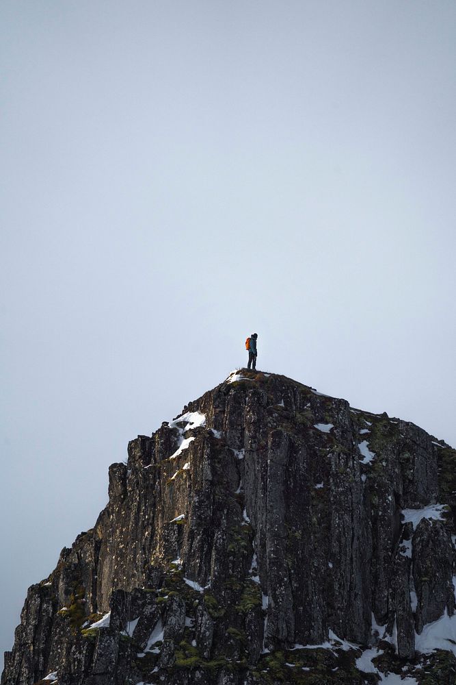 Backpacker hiking up Segla mountain in Norway