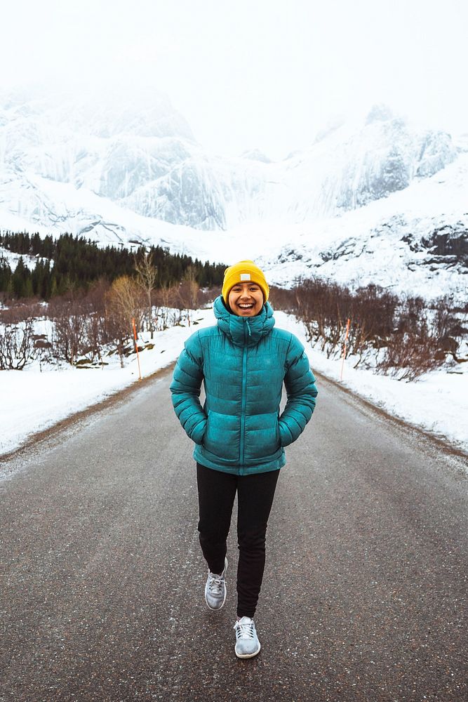 Young woman hiking up the road in Norway