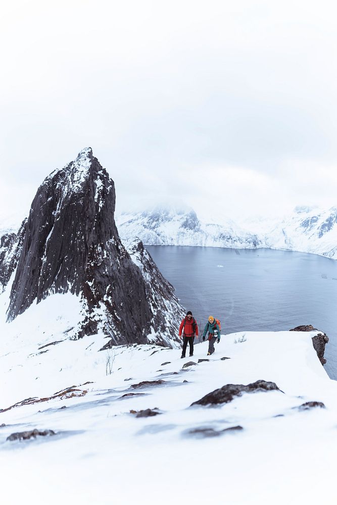 Backpackers hiking up Segla mountain, Norway