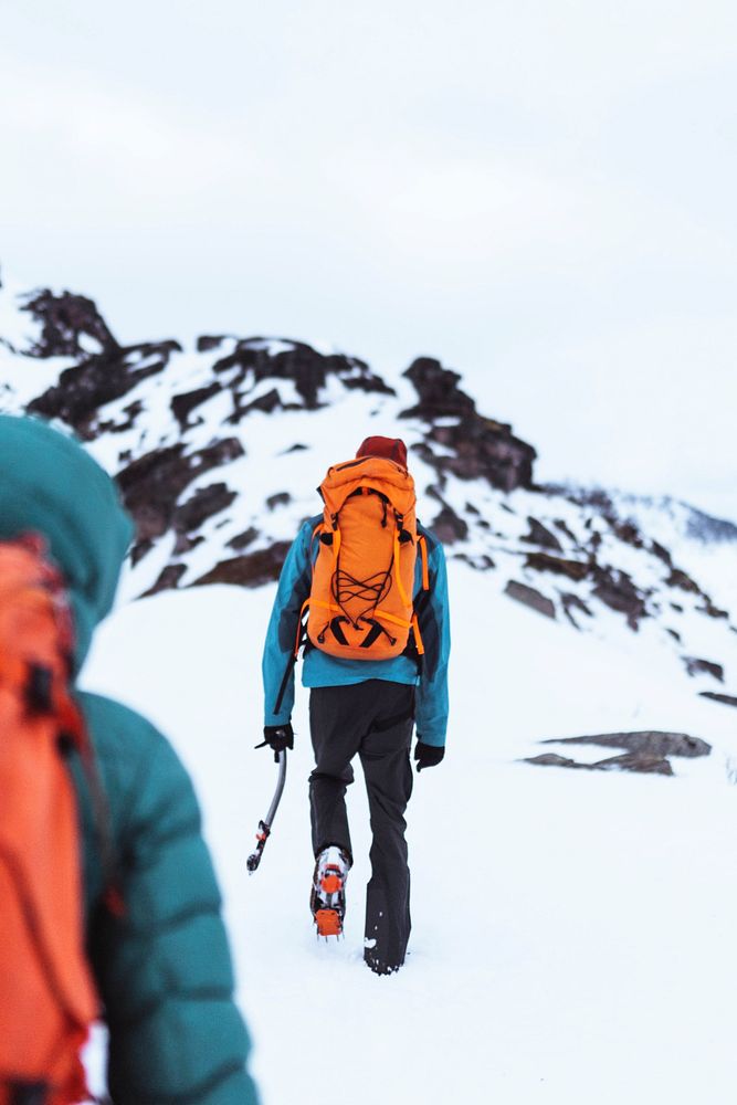 Backpackers hiking up the Segla mountain, Norway