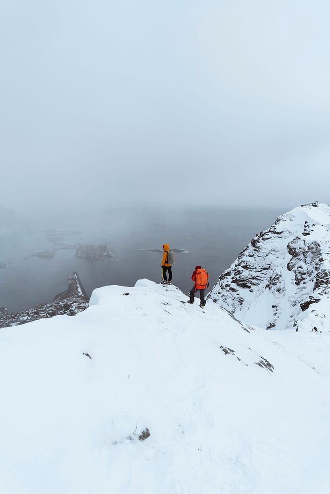 Hikers up in Reinebringen in the Lofoten Islands, Norway