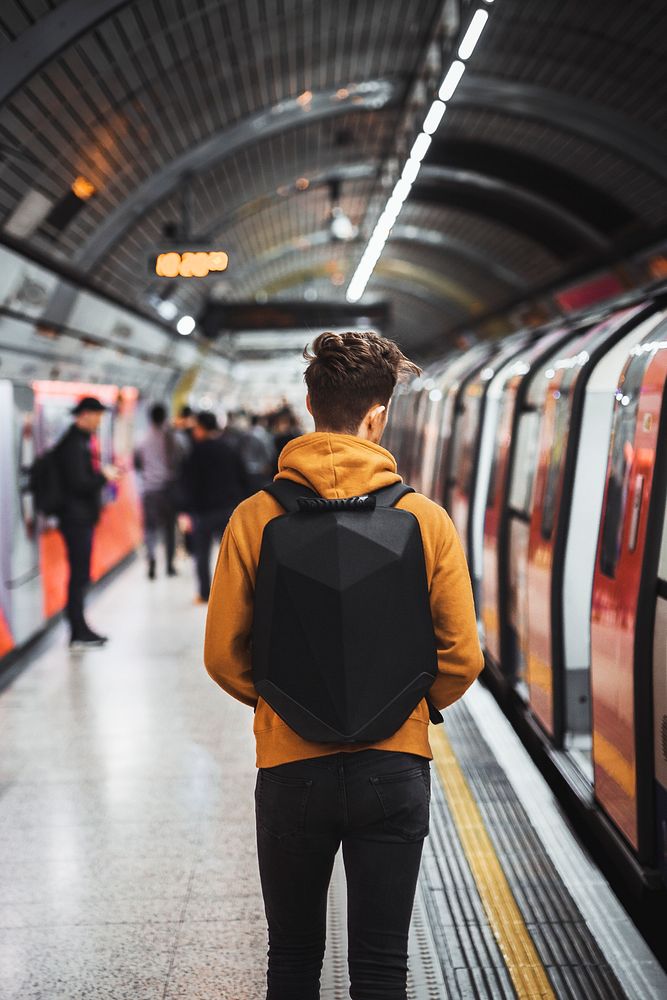 Man walking inside of underground tube in London