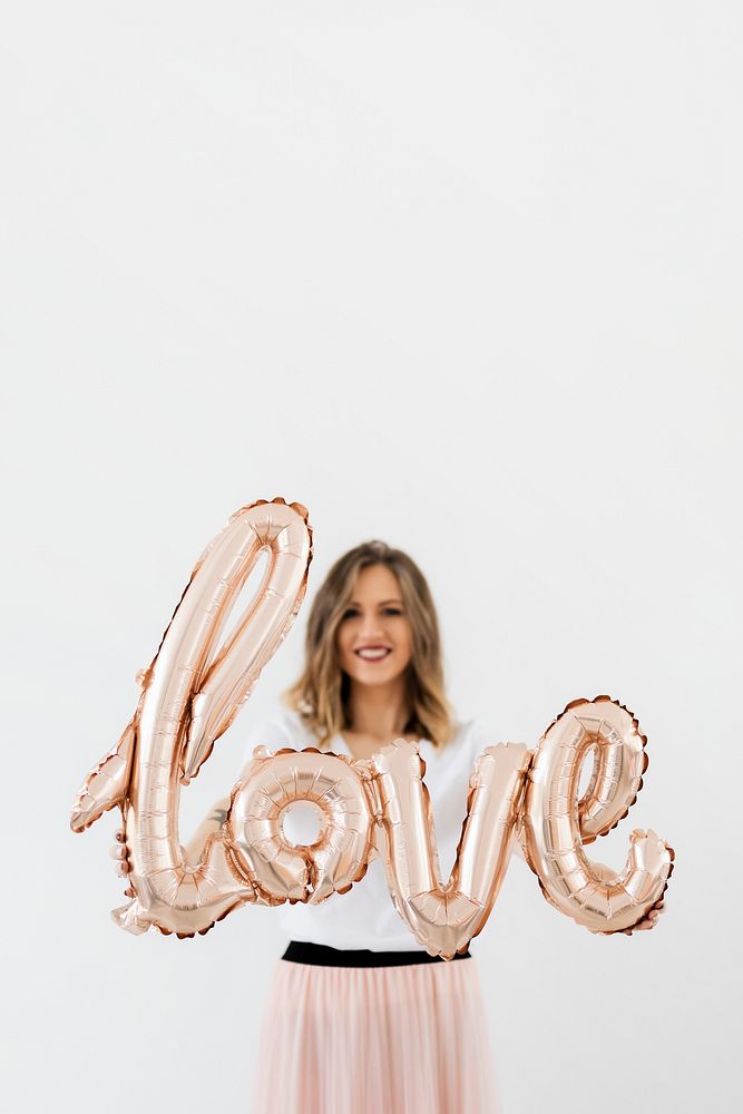 Woman holding a love foil balloon