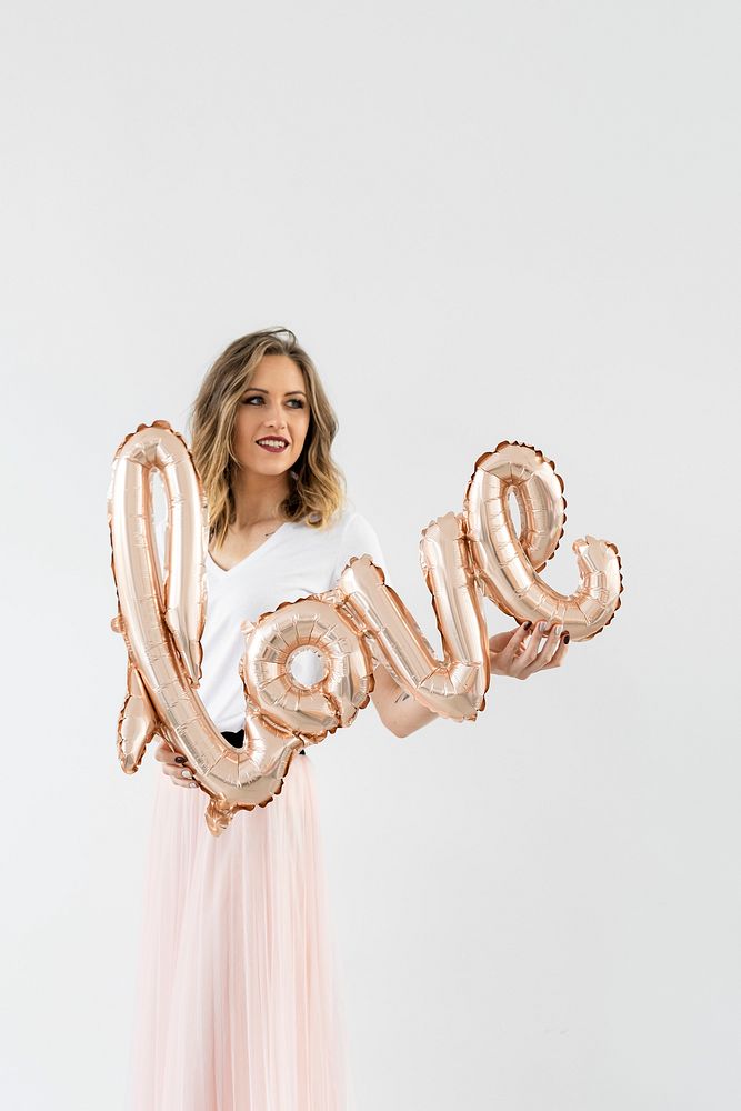 Woman holding a love foil balloon