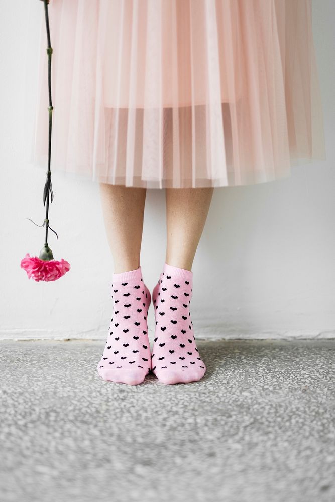 Woman holding a flower wearing pink socks