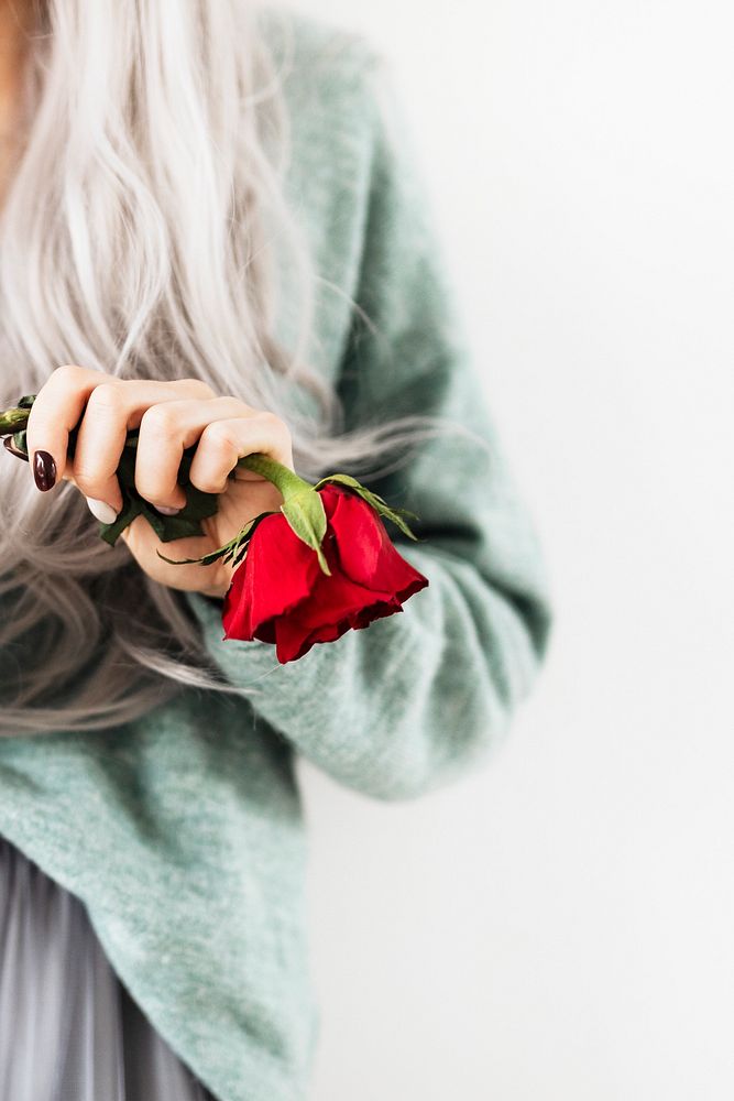 Pastel goth woman holding a red rose
