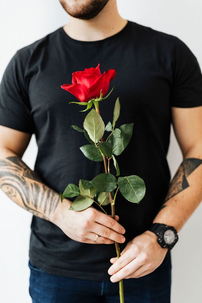 Romantic tattooed man with a rose