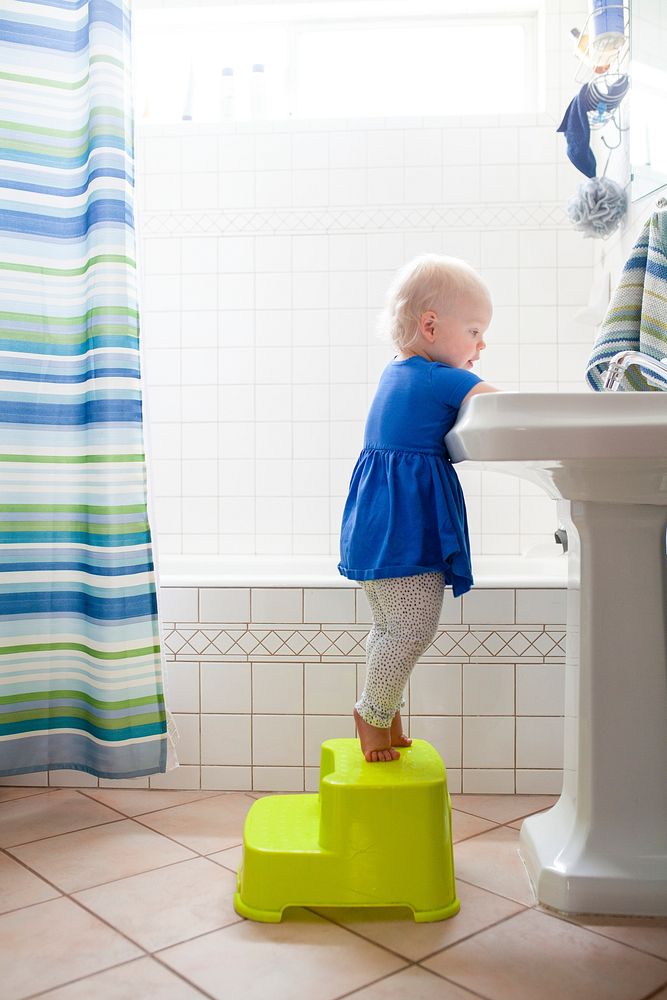 Little girl washing her hands in the sink health photo