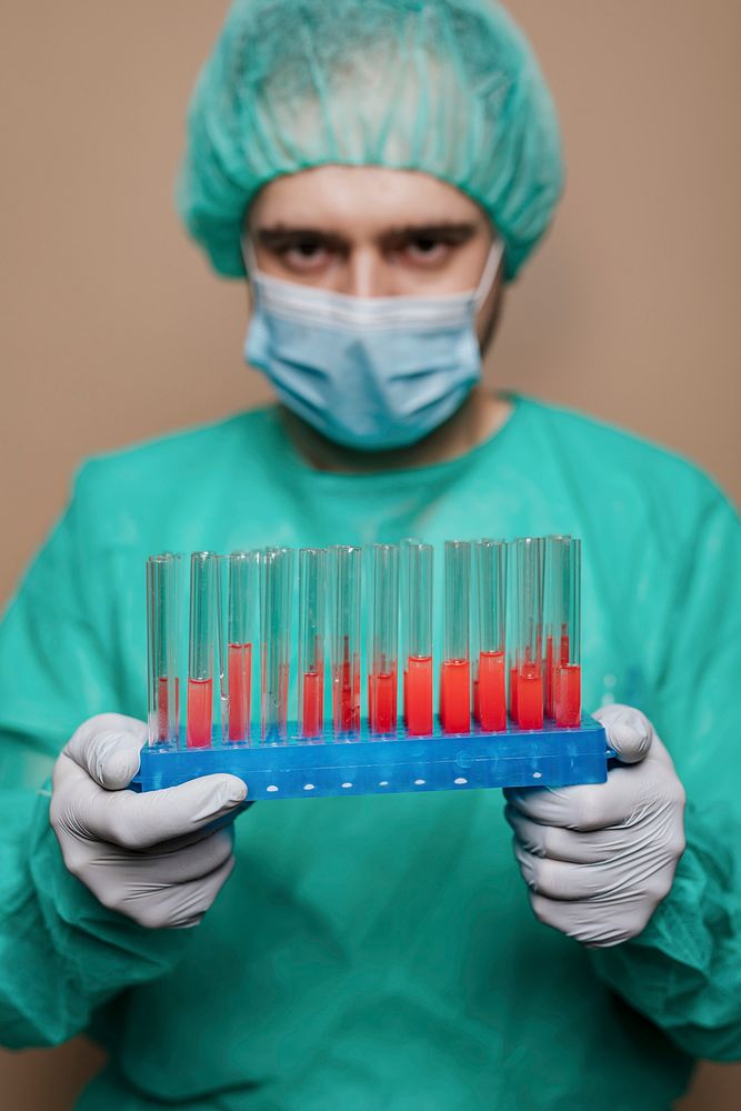 Surgeon holding test tube samples