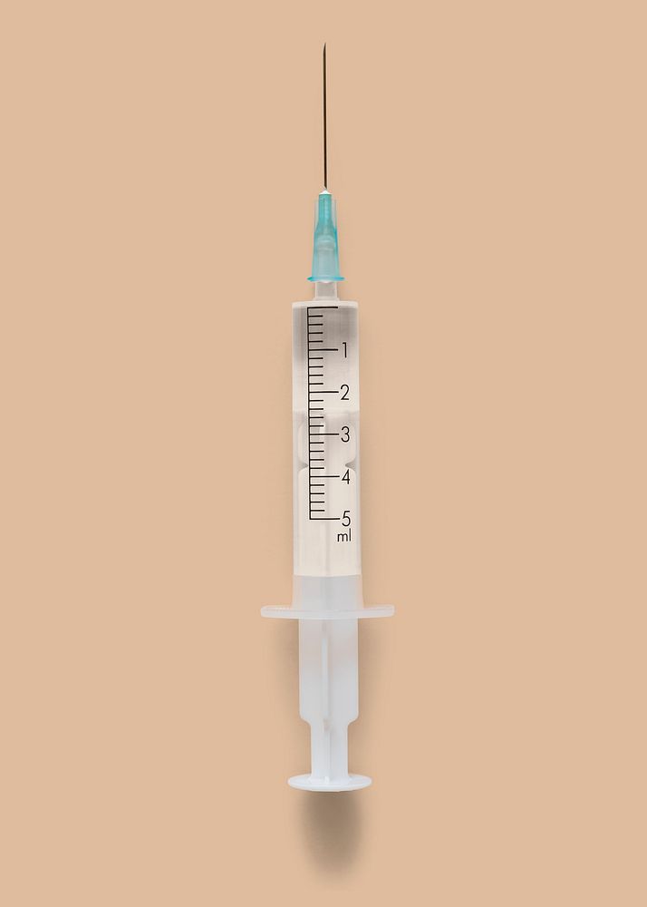 Closeup of a syringe on a brown background