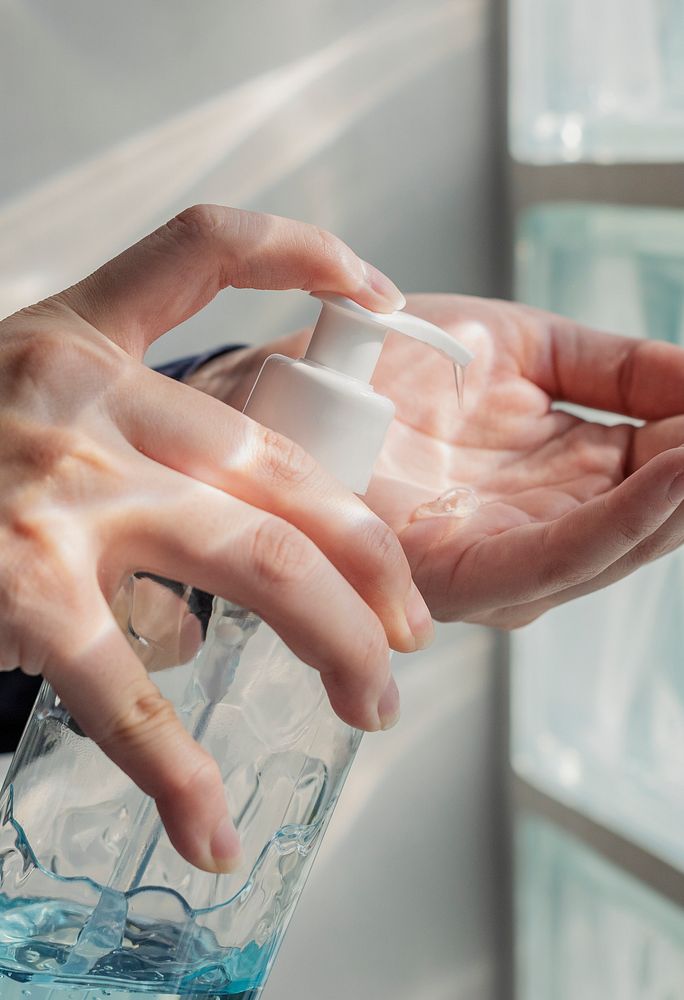 Woman cleaning hands with a hand sanitizer gel to prevent coronavirus contamination
