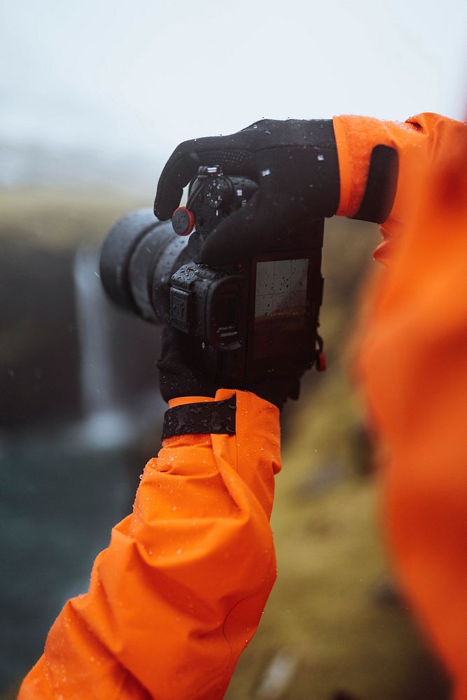 Photographer at M&uacute;lafossur waterfall in the Faroe Islands, part of the Kingdom of Denmark