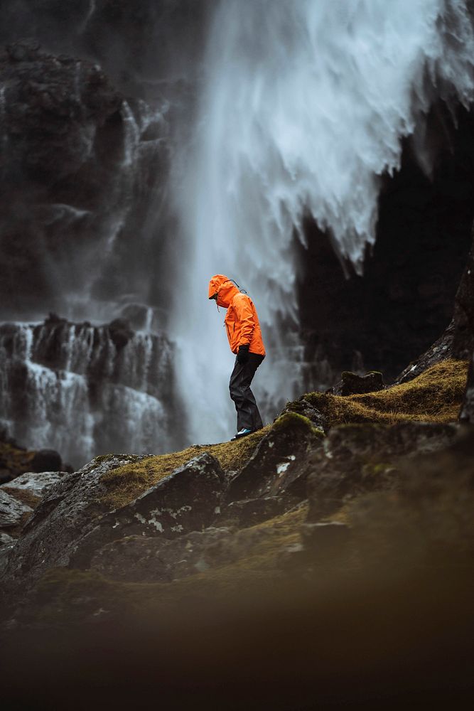 Traveler at Foss&aacute; waterfall in the Faroe Islands