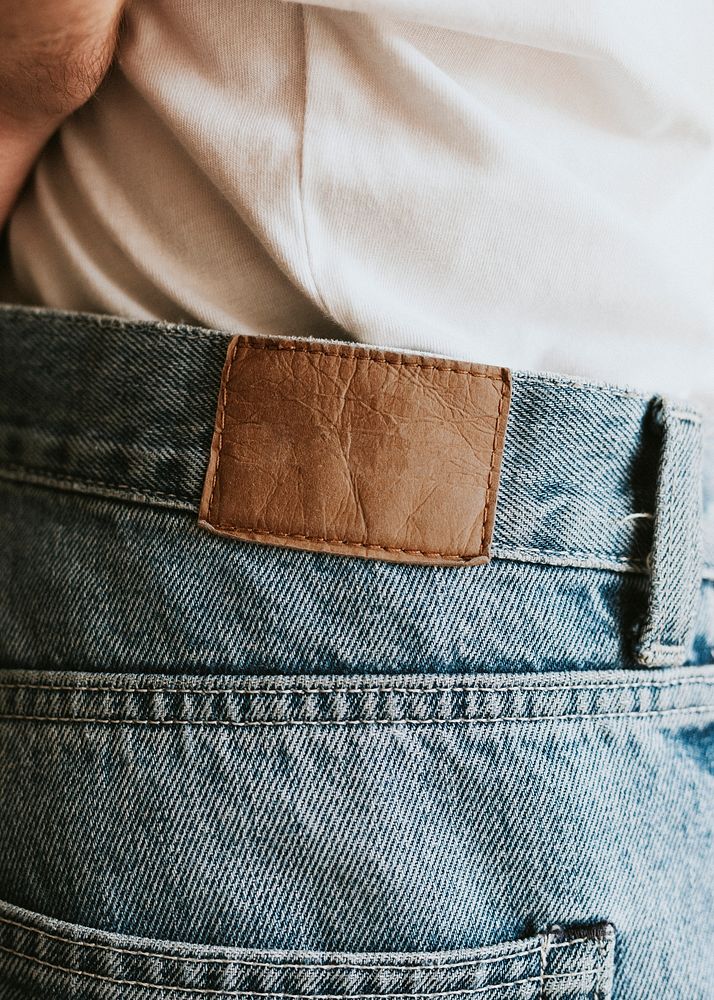 Man in blue jeans with brown tag