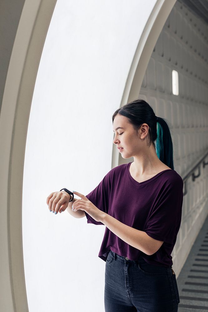 Girl using smartwatch to connect to a large interactive screen