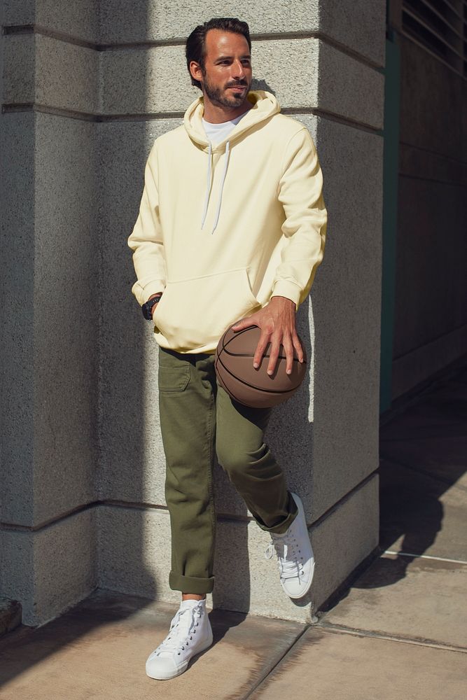 Yellow hoodie on a man with basketball